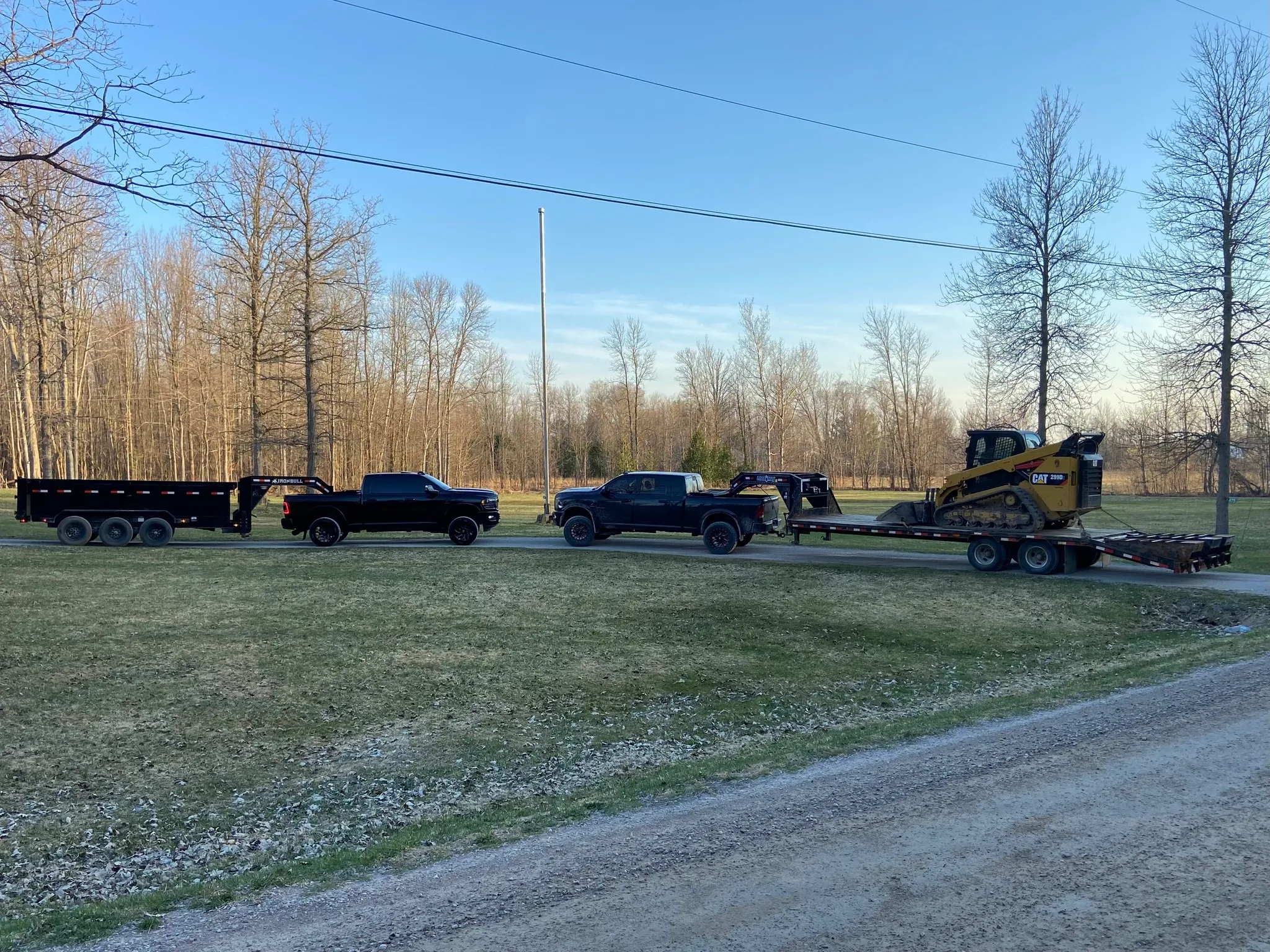 Tandem Services trucks and equipment lined up on a rural property
